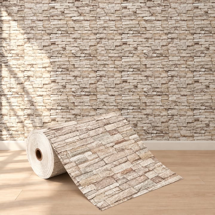 Sand stone foam brick roll in front of a living room wall of pale stacked stone