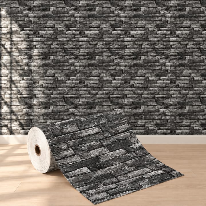 Charcoal stone foam roll in front of a dark stone TV wall