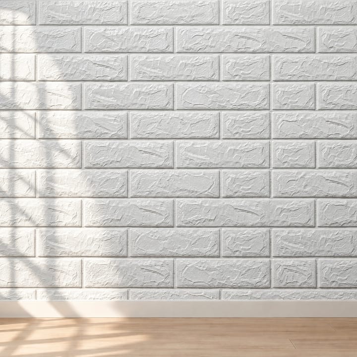 Stack of white foam brick tiles with a raised brick relief