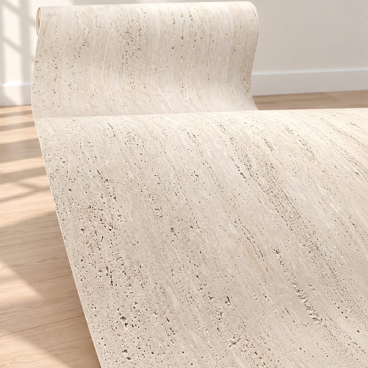 Cream travertine-look sheet curving off its roll