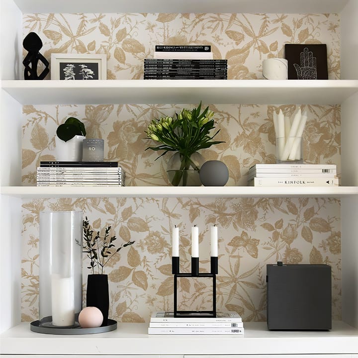 Built-in shelves backed with champagne rose wallpaper