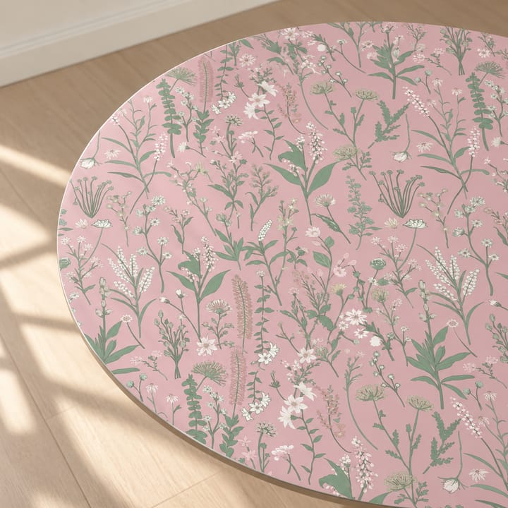 Blush herb print in pale pink with green herbs, used on a round tabletop