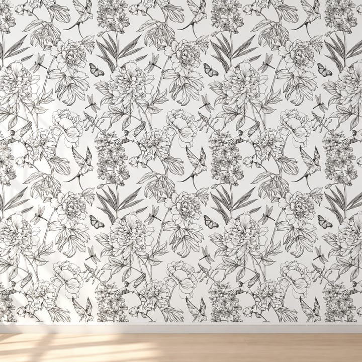 Bedroom wall in peony and butterfly sketch wallpaper behind a black headboard