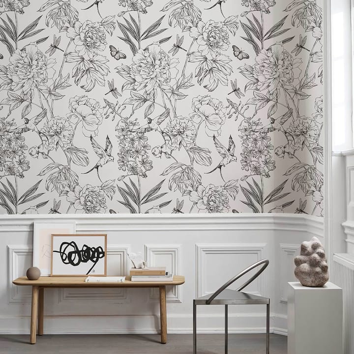 Sketch peony wallpaper above white wainscoting behind a wooden bench