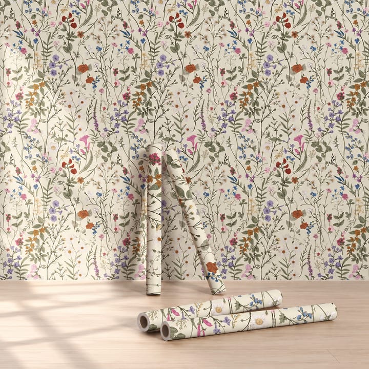 Tall wildflower wallpaper with rolls leaning against the wall