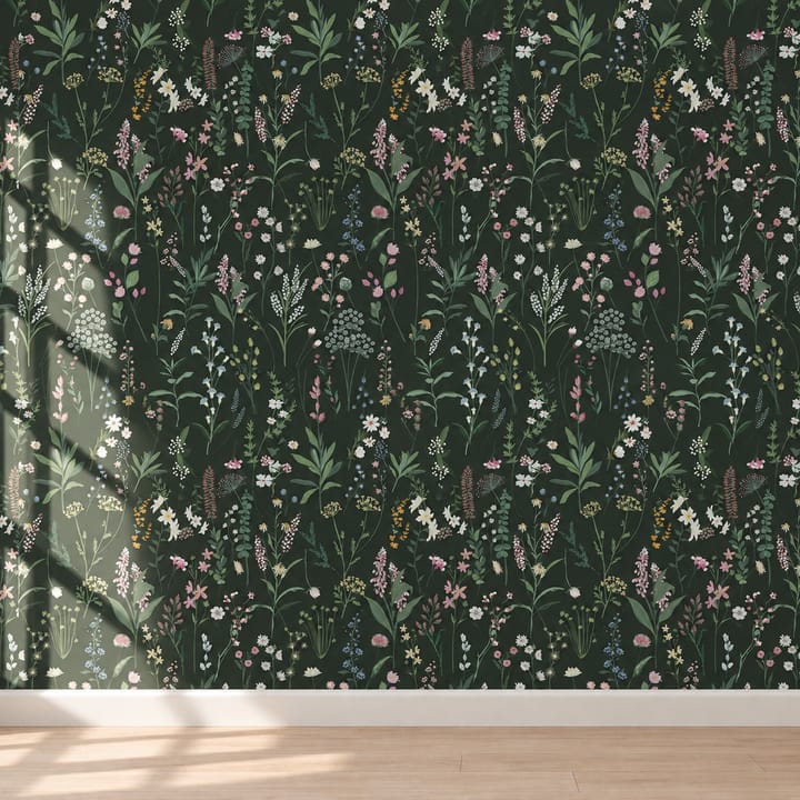 Forest meadow wallpaper on dark green behind a gray sofa