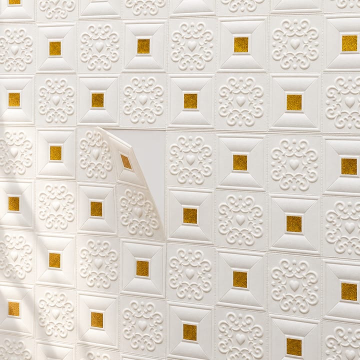 Woman fitting gold-accent embossed foam tiles low on a wall