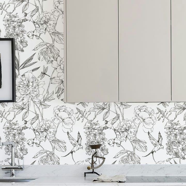 Sketch peony wallpaper on a kitchen wall below pale cabinets