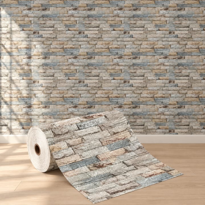 Slate stone foam brick roll unrolled in front of a bedroom wall in gray and blue stacked brick