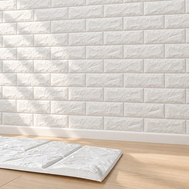 Close-ups of a white foam brick panel being peeled from its backing and pressed to a wall