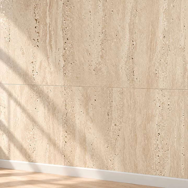 Hand on a cream travertine-look wall beside a light switch