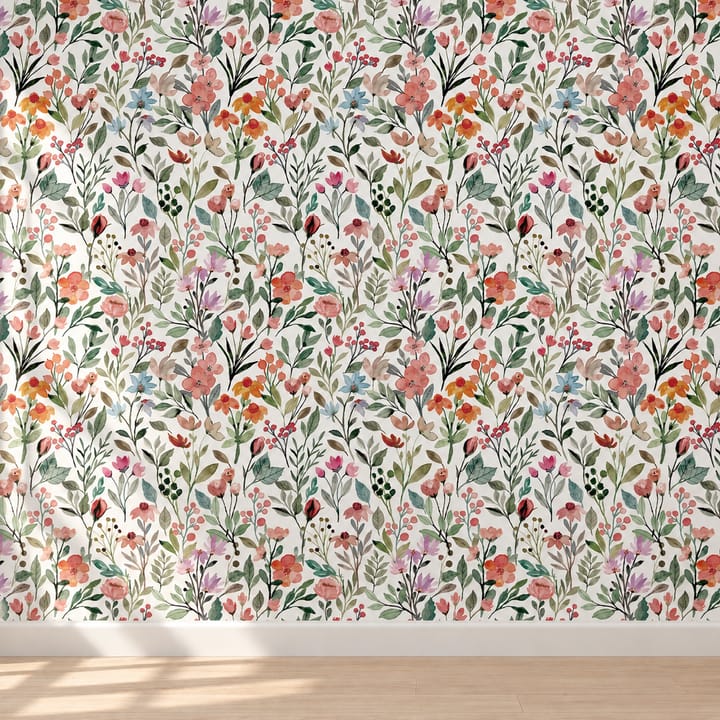 Summer bloom wallpaper with dense red and blue flowers behind a cane bench